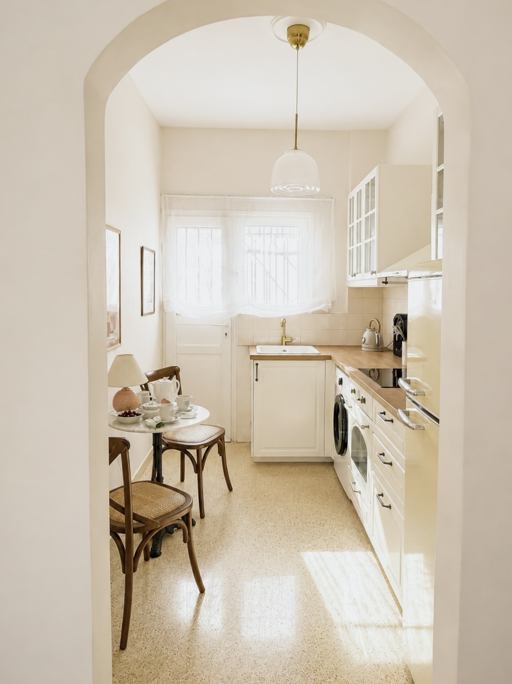 Galley kitchen with bistro breakfast table and bentwood chairs