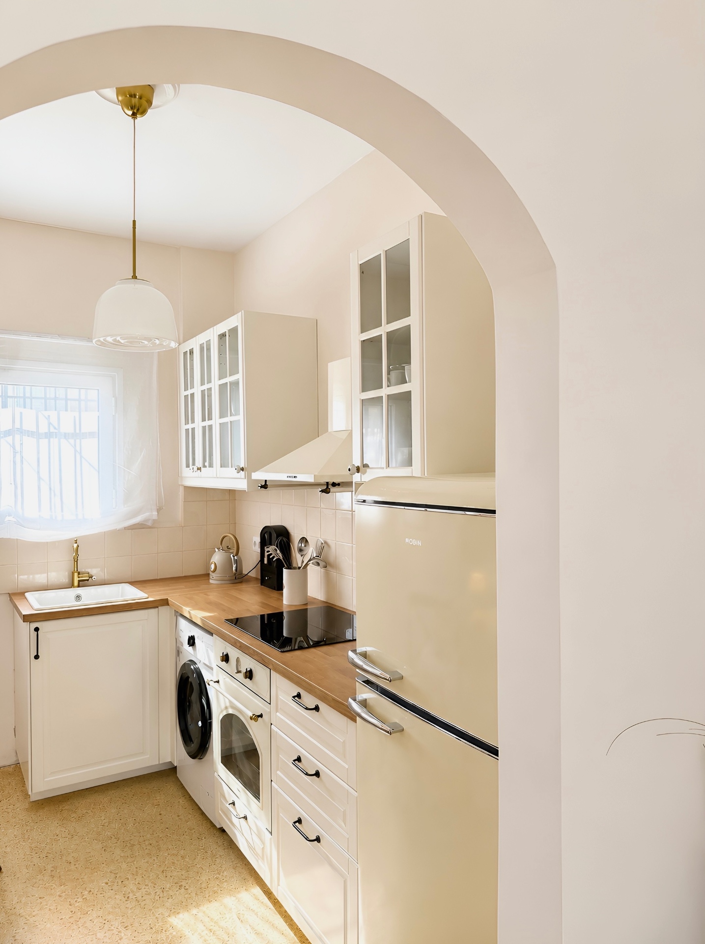 Arched entrance to the vintage cream kitchen