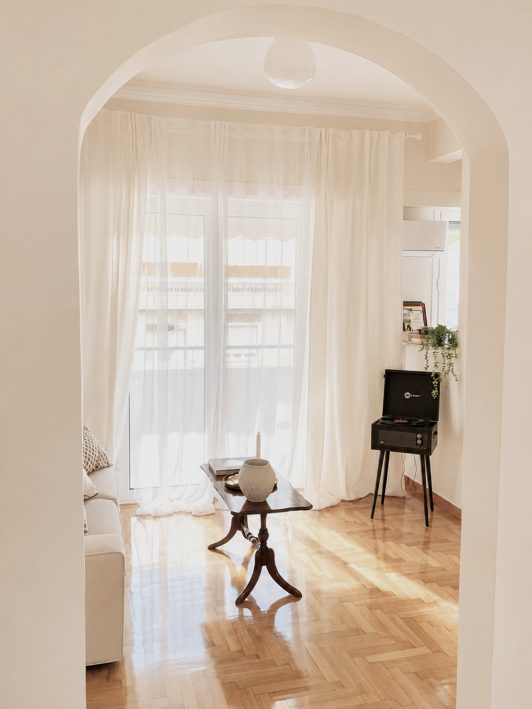 View through arched doorway to balcony and record player