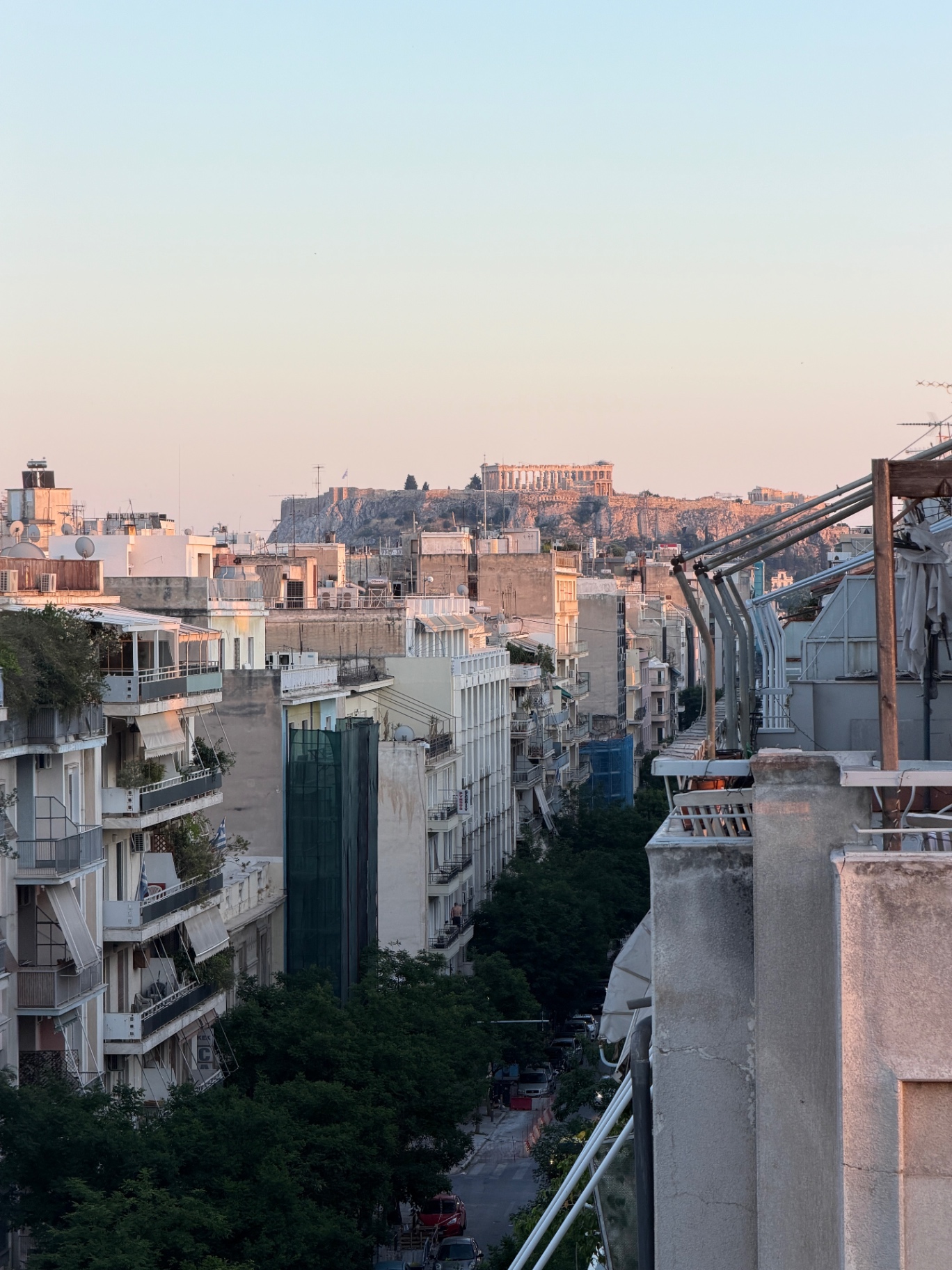 Pastel sunset view from the terrace toward the Acropolis