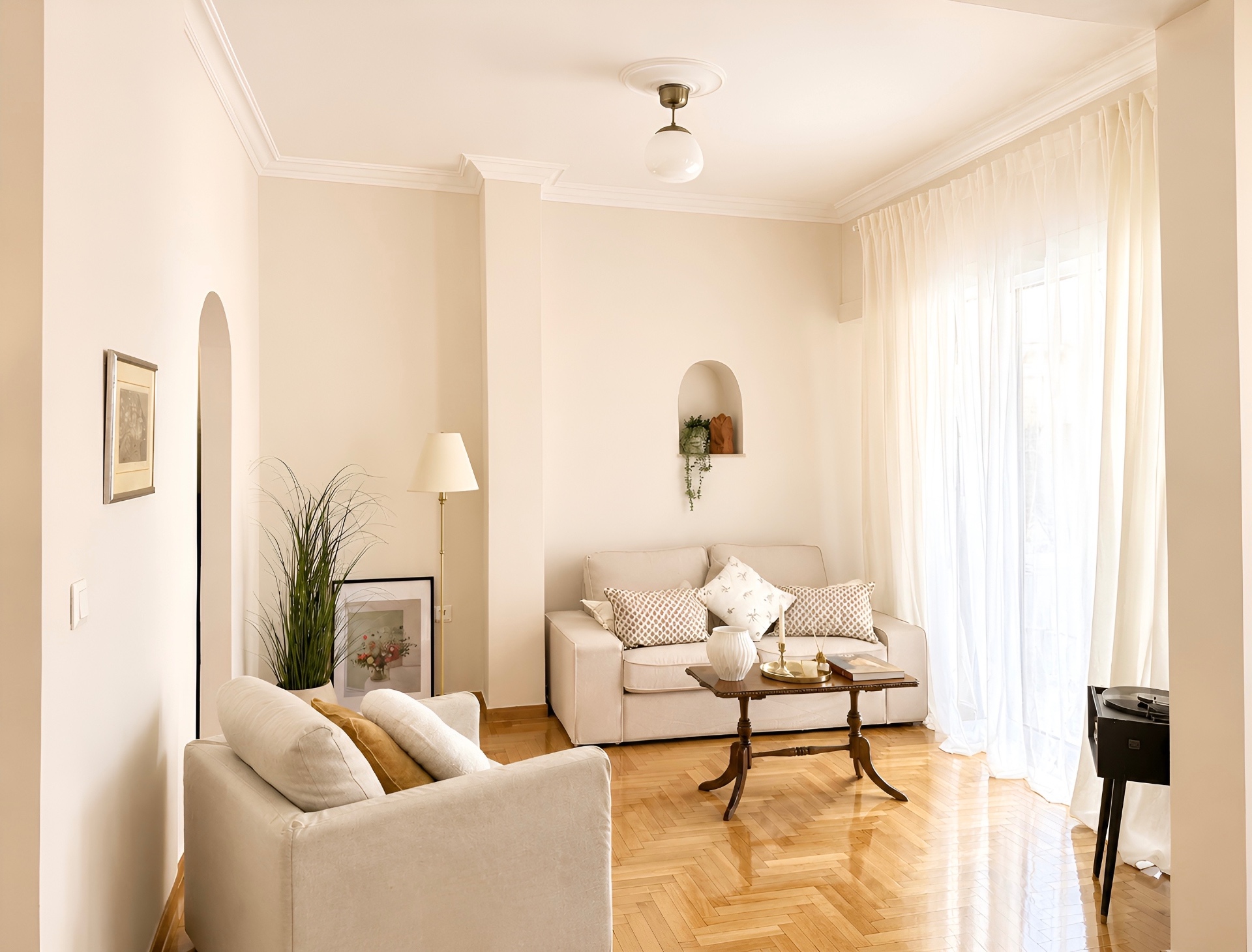 Sunlit living room with vintage parquet and arched niche