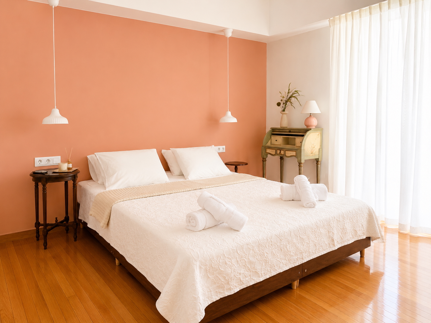 Bedroom with blush accent wall and soft morning light