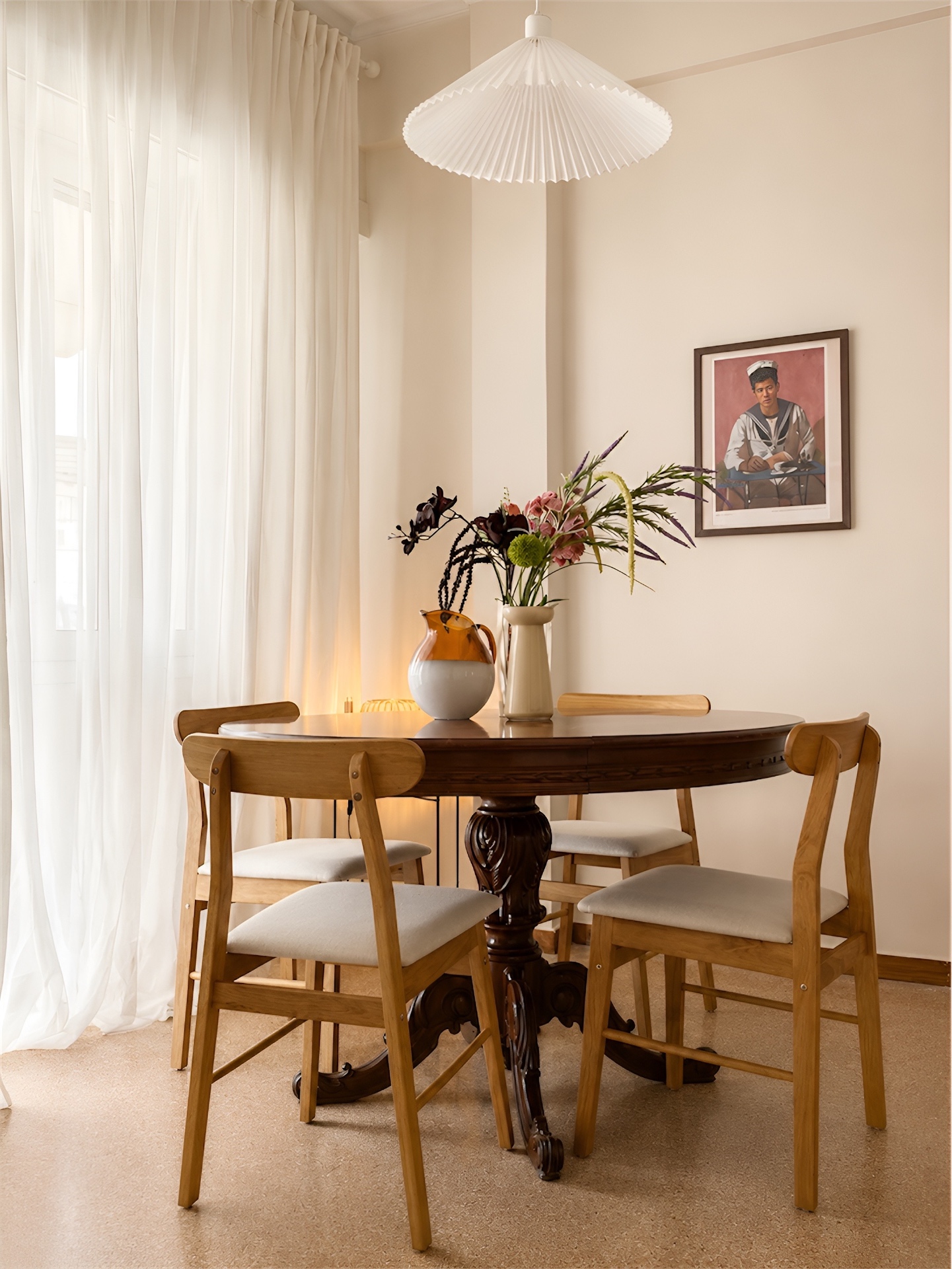 Vintage dining table with carved pedestal and pleated pendant lamp
