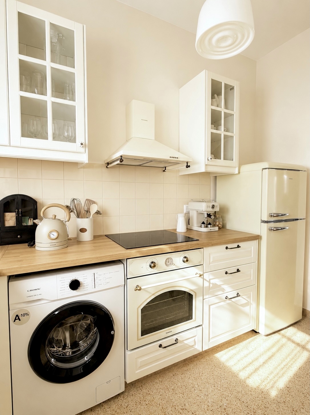 Cream kitchen with retro fridge, oven and butcher block counter
