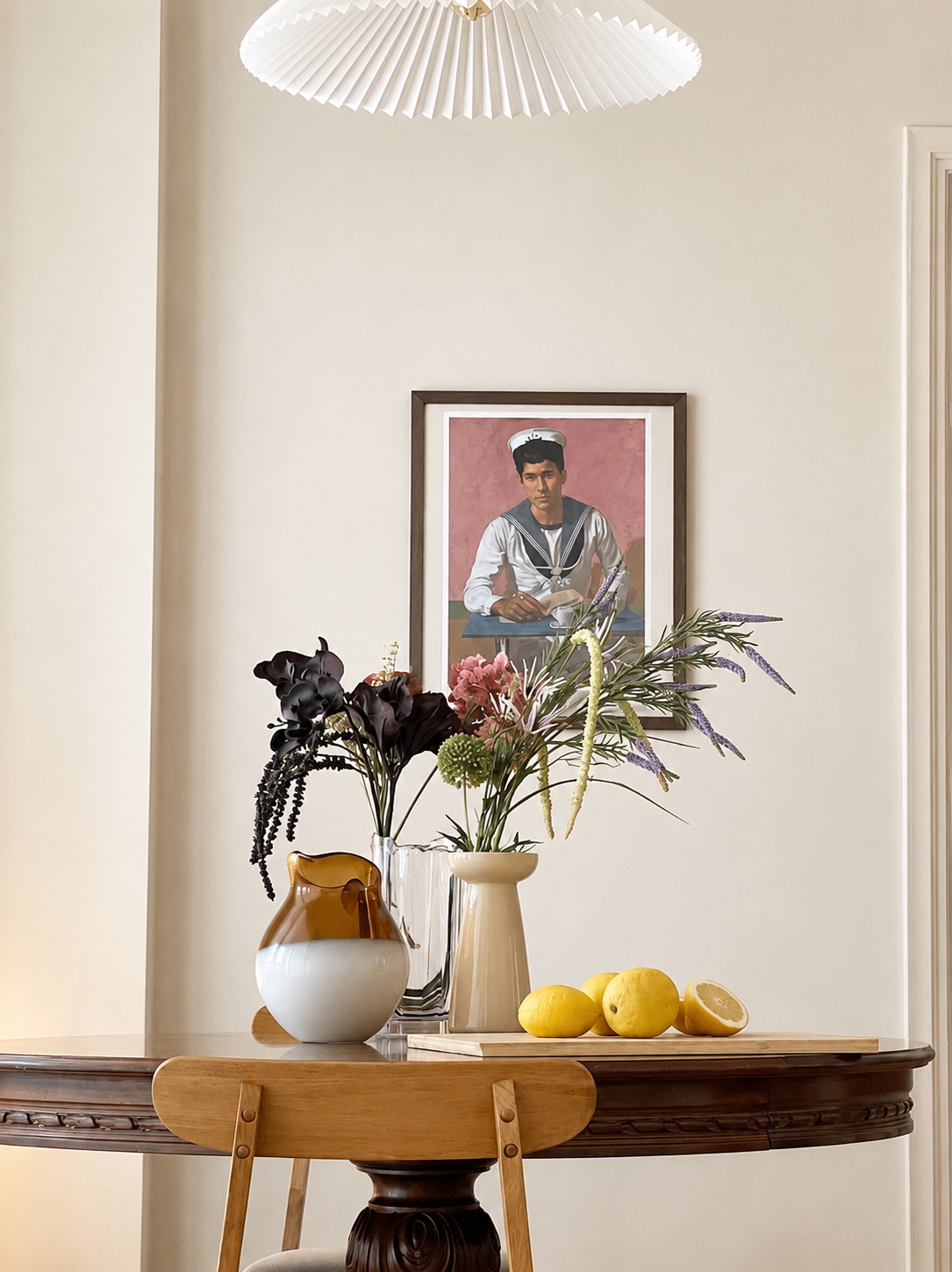 Still life with sailor portrait, fresh flowers and lemons on dining table