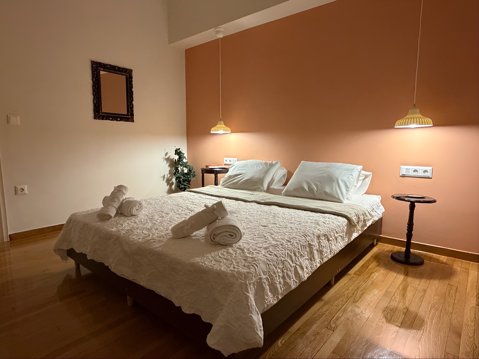 Bedroom at dusk with pendant lights glowing above the bed