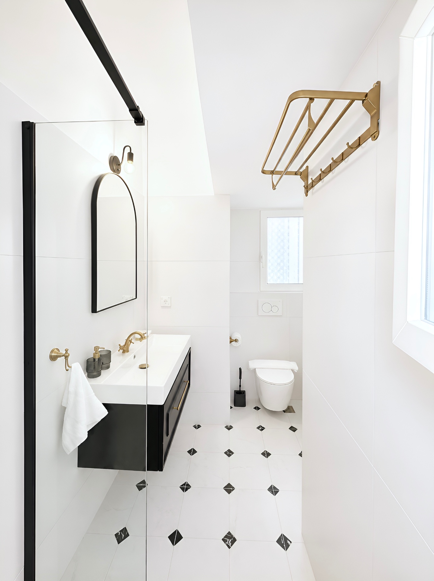 Bathroom view with brass towel rack and patterned marble floor